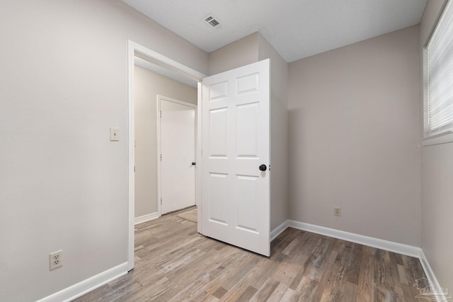 unfurnished bedroom featuring light wood-type flooring