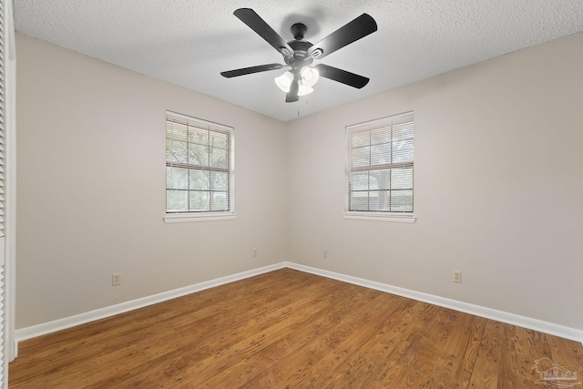 empty room with hardwood / wood-style floors, a textured ceiling, and ceiling fan