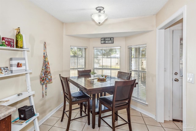 dining room with light tile patterned floors and a textured ceiling