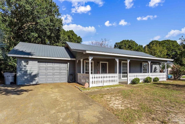 single story home featuring a porch, a garage, and a front lawn