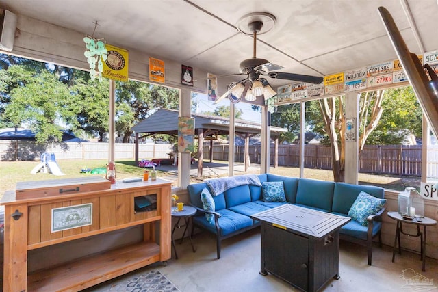 sunroom / solarium with a wealth of natural light and ceiling fan