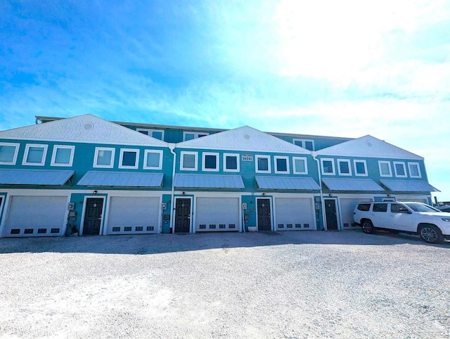 14391 Perdido Key Dr Unit D, Pensacola, FL 32507 - townhome / multi-family property with an attached garage, driveway, and metal roof