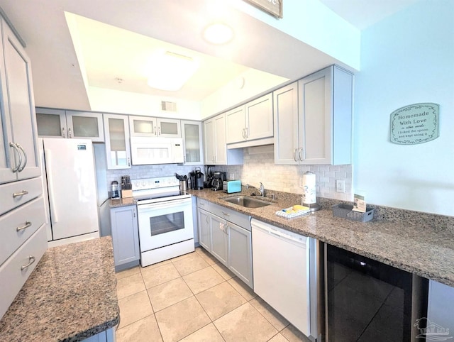 14391 Perdido Key Dr Unit D, Pensacola, FL 32507 - kitchen with white appliances, a sink, decorative backsplash, light tile patterned flooring, and gray cabinetry