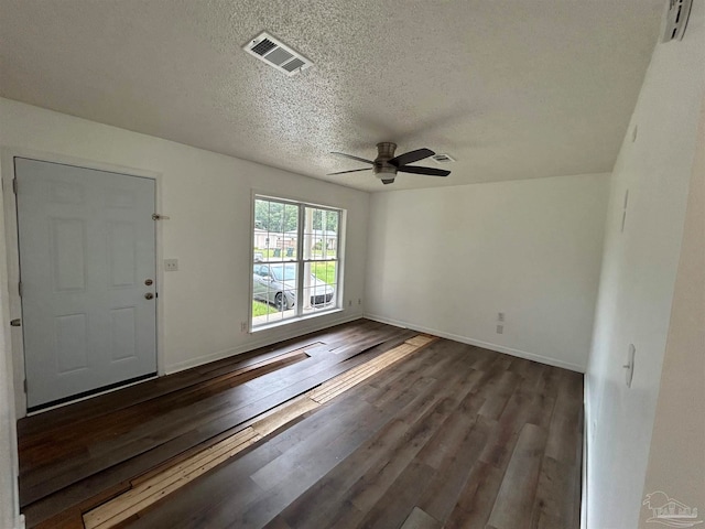 entryway featuring dark hardwood / wood-style flooring, ceiling fan, and a textured ceiling