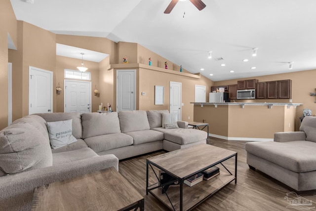 living area with recessed lighting, visible vents, lofted ceiling, and wood finished floors