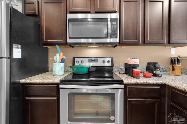 kitchen featuring stainless steel appliances and dark brown cabinetry