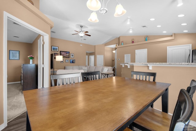 dining area featuring vaulted ceiling, recessed lighting, ceiling fan with notable chandelier, and visible vents