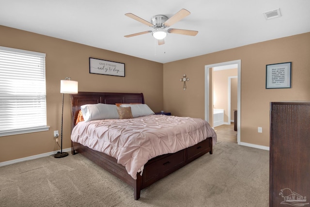 bedroom with a ceiling fan, baseboards, visible vents, light carpet, and connected bathroom