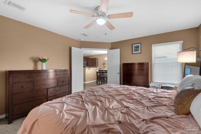 bedroom featuring light colored carpet, baseboards, and visible vents