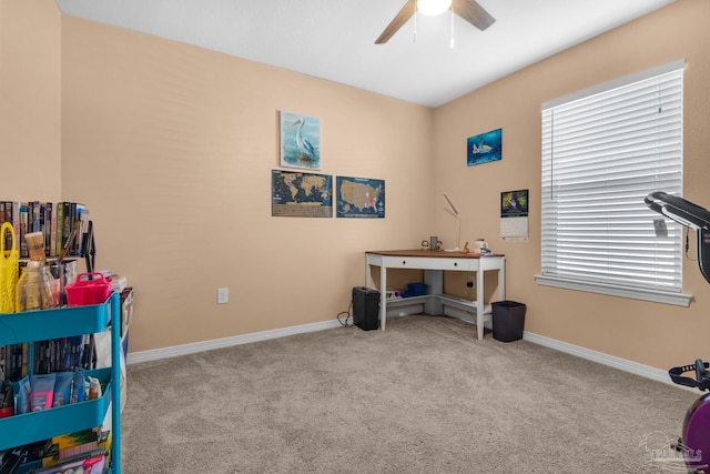 interior space featuring carpet flooring, a ceiling fan, and baseboards