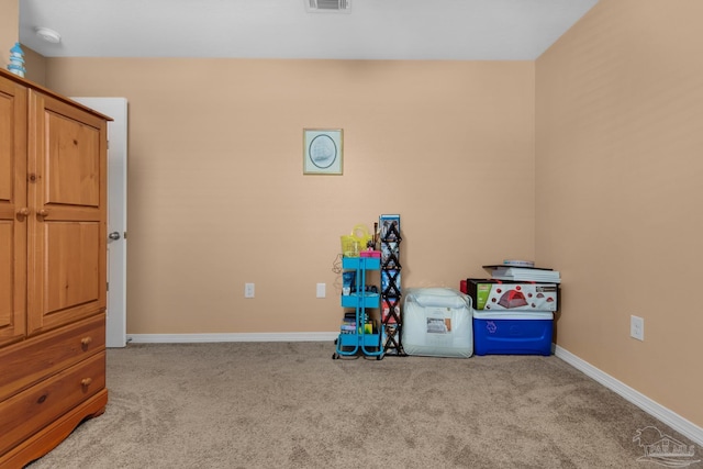 rec room featuring baseboards, visible vents, and carpet floors