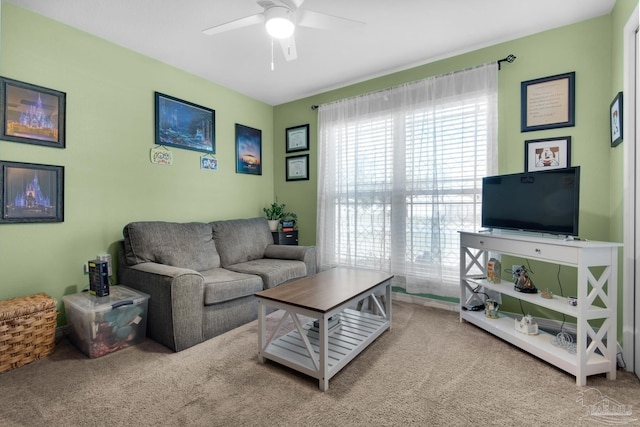 carpeted living area with ceiling fan