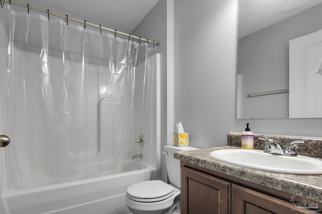 full bathroom featuring toilet, shower / bath combo, vanity, and a textured wall