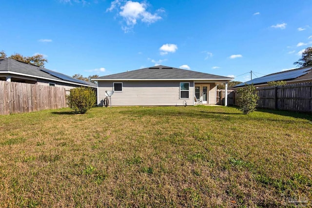 back of property featuring a lawn and a fenced backyard