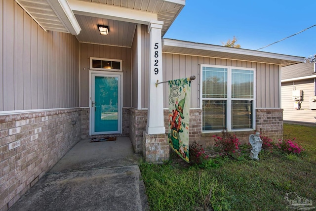 property entrance featuring brick siding