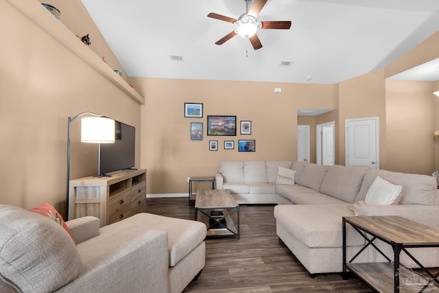 living room featuring visible vents, lofted ceiling, dark wood-type flooring, and a ceiling fan