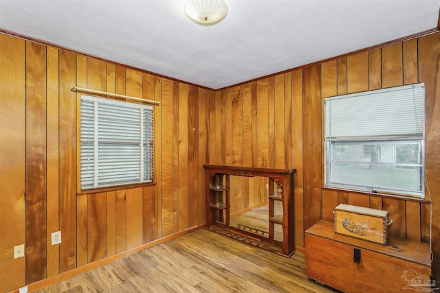 empty room featuring light wood-type flooring and crown molding