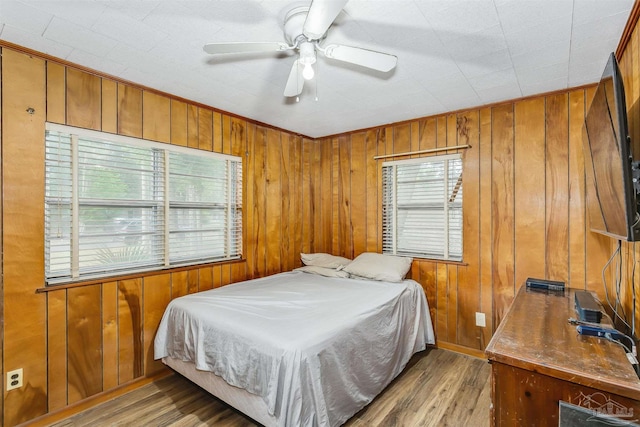 bedroom with ceiling fan and wood-type flooring