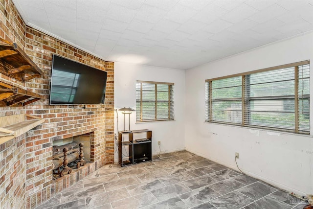 unfurnished living room with a brick fireplace