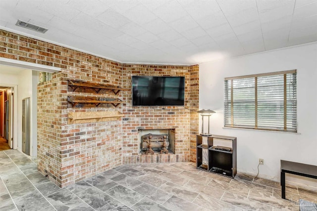 living room with brick wall and crown molding