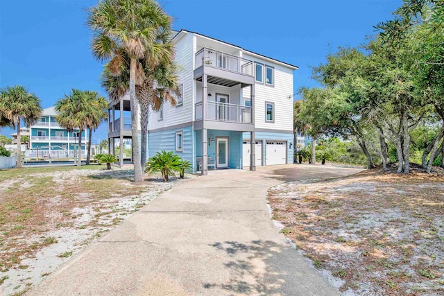 view of front of property featuring a garage and a balcony