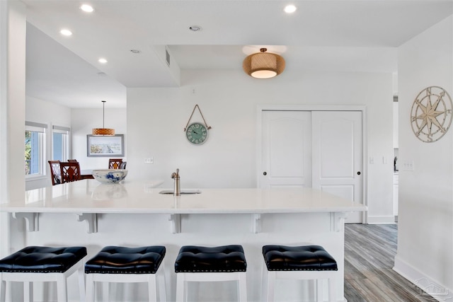 kitchen with a kitchen bar and light wood-type flooring