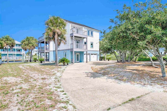 view of front of property featuring a balcony and a garage