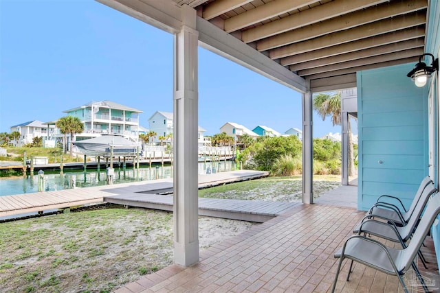 view of patio with a boat dock and a water view