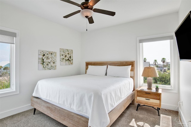 bedroom featuring carpet flooring, multiple windows, and ceiling fan