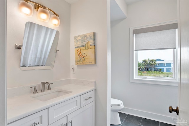 bathroom featuring tile patterned floors, vanity, and toilet