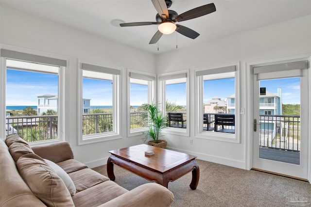 sunroom featuring ceiling fan and a wealth of natural light