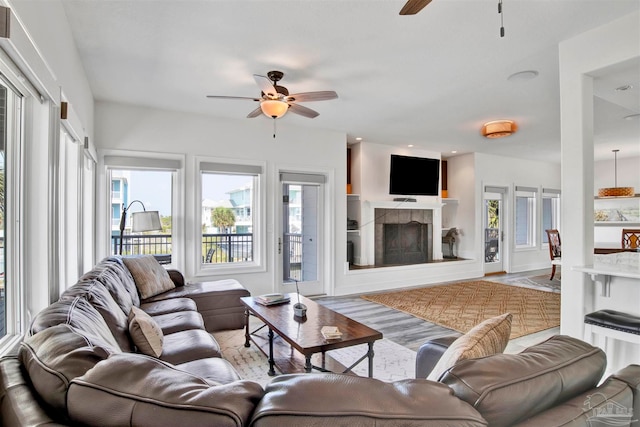 living room with light hardwood / wood-style flooring and ceiling fan