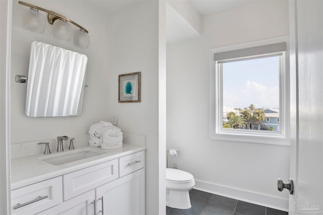 bathroom featuring tile patterned flooring, vanity, and toilet