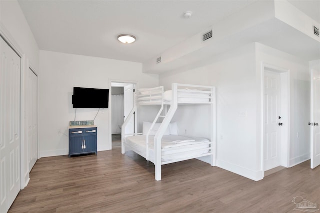 unfurnished bedroom featuring a closet and dark hardwood / wood-style flooring