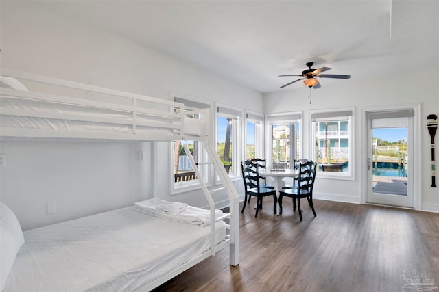 bedroom featuring access to outside, ceiling fan, and dark hardwood / wood-style flooring