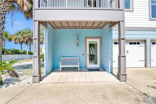 doorway to property featuring a balcony and a garage