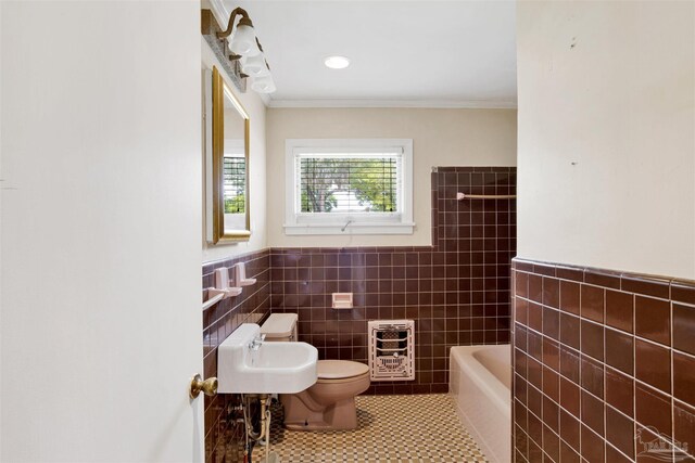 1001 E Bobe St, Pensacola, FL 32503 - bathroom featuring tile walls, tile patterned flooring, toilet, heating unit, and ornamental molding