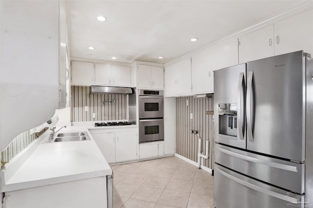 1001 E Bobe St, Pensacola, FL 32503 - kitchen with appliances with stainless steel finishes, a sink, light tile patterned floors, ventilation hood, and light countertops