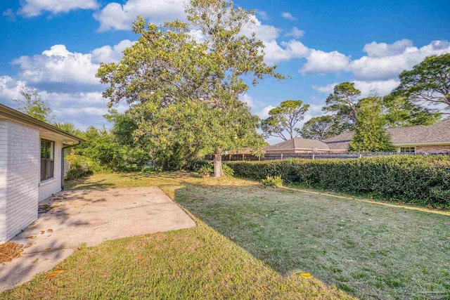 view of yard featuring fence and a patio area