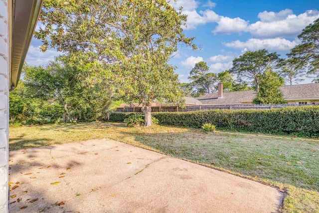 view of yard featuring fence and a patio