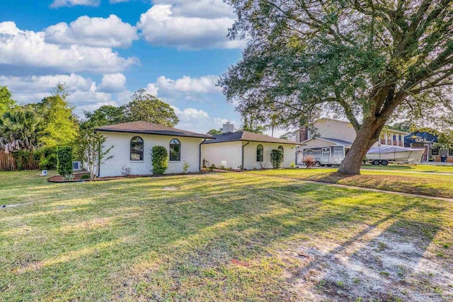 view of front of property with a chimney and a front lawn