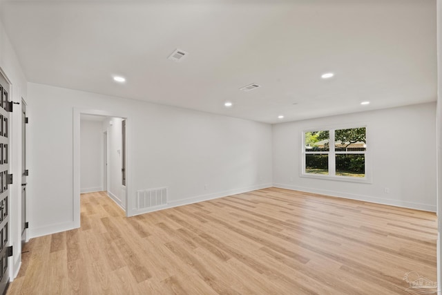 unfurnished room featuring light wood-type flooring, visible vents, and recessed lighting
