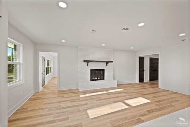 unfurnished living room with recessed lighting, light wood-type flooring, visible vents, and baseboards