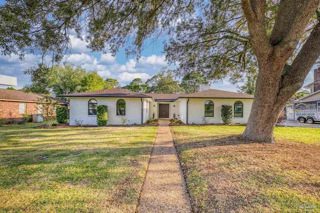 ranch-style house featuring a front yard and central AC