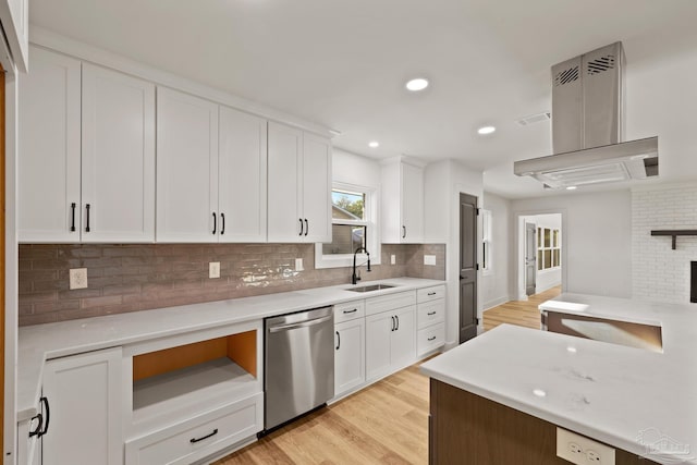 kitchen featuring dishwasher, tasteful backsplash, a sink, and light countertops
