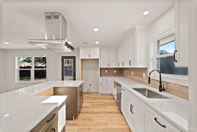kitchen featuring recessed lighting, a sink, light wood finished floors, and ventilation hood