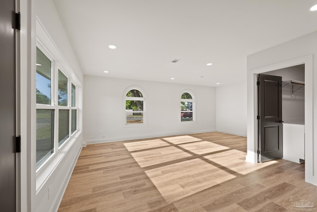 interior space with baseboards, recessed lighting, and light wood-type flooring