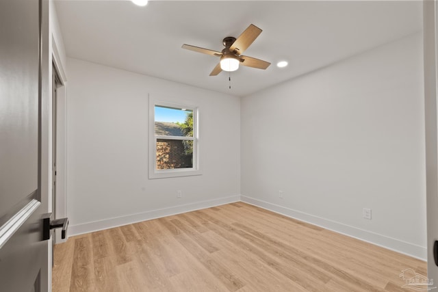spare room featuring recessed lighting, baseboards, a ceiling fan, and light wood-style flooring