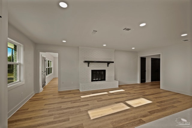 unfurnished living room with recessed lighting, light wood-style floors, visible vents, and baseboards