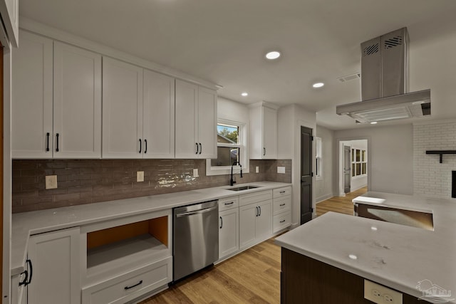 kitchen featuring recessed lighting, light countertops, dishwasher, a sink, and light wood-style flooring